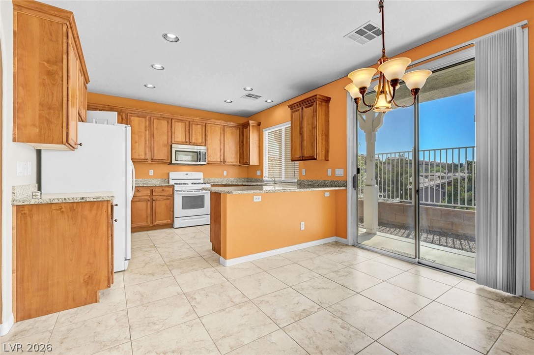 977 Sparkling Light Street Henderson, NV 89052 - Photo 28 of 75 This spacious kitchen offers ample granite counter space and a private outdoor balcony with hillside views.