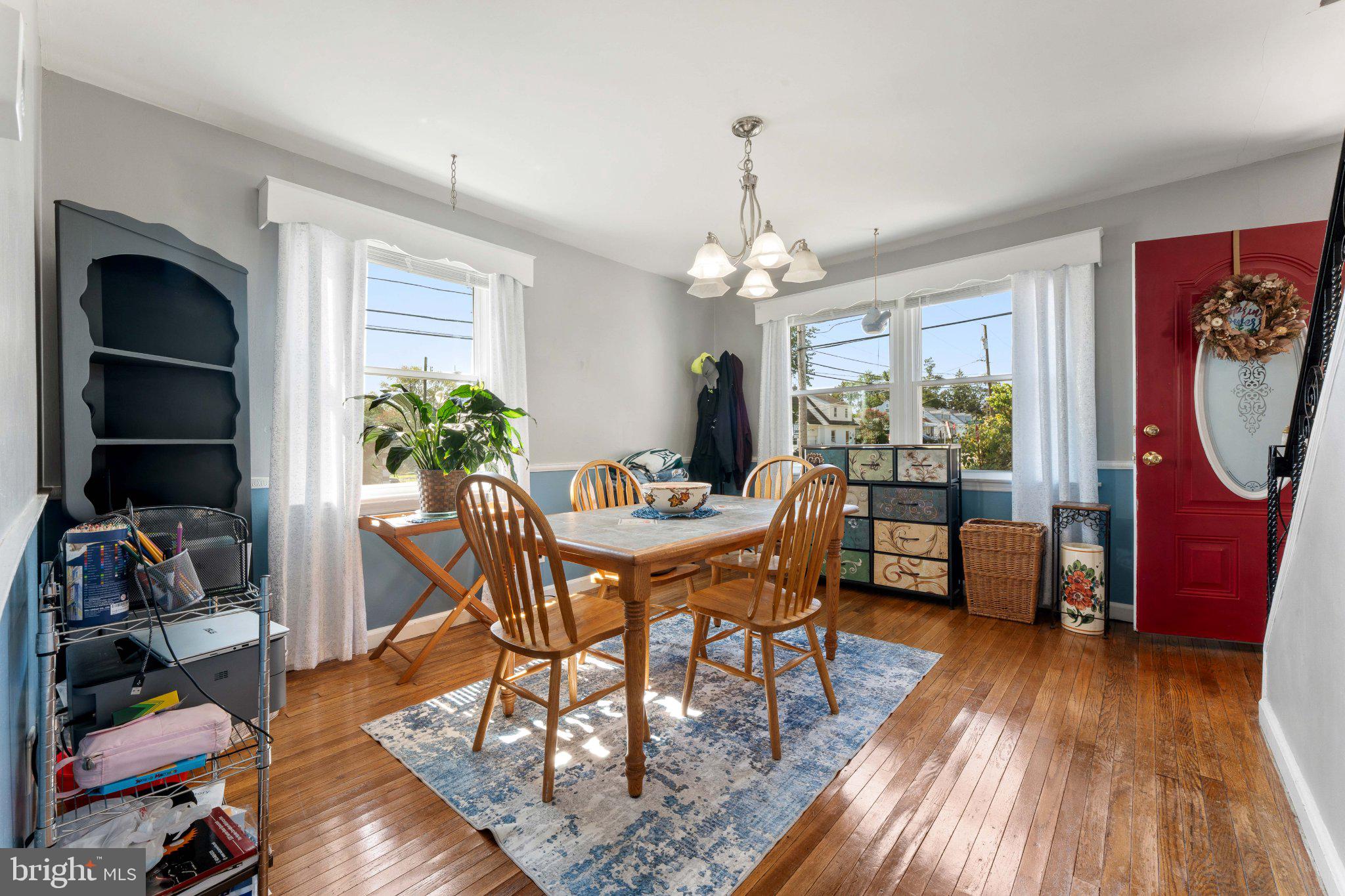 329 Ashland Avenue Secane, PA 19018 - Photo 15 of 33 a dining room with furniture a chandelier and wooden floor