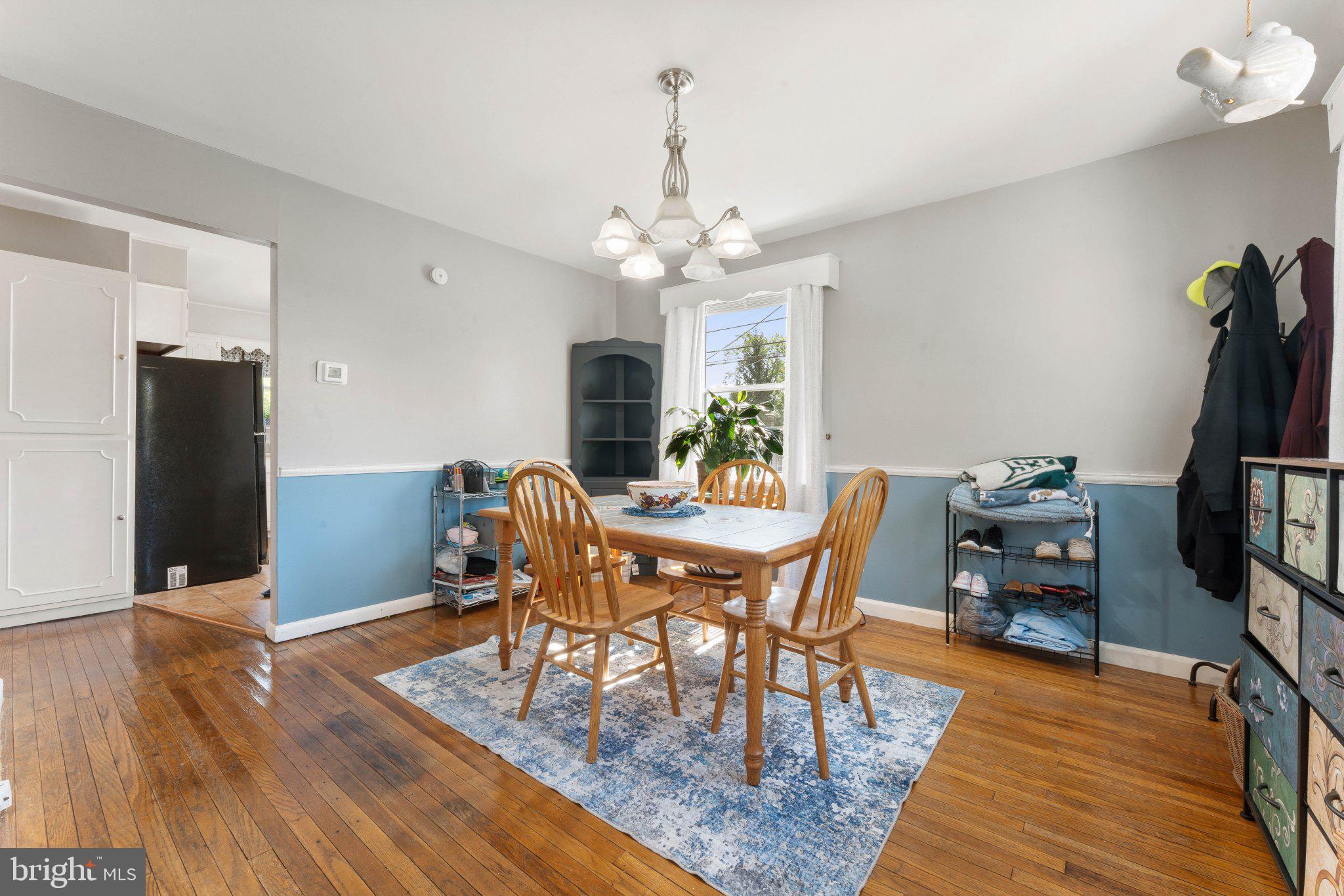 329 Ashland Avenue Secane, PA 19018 - Photo 16 of 33 a dining room with furniture a chandelier and wooden floor