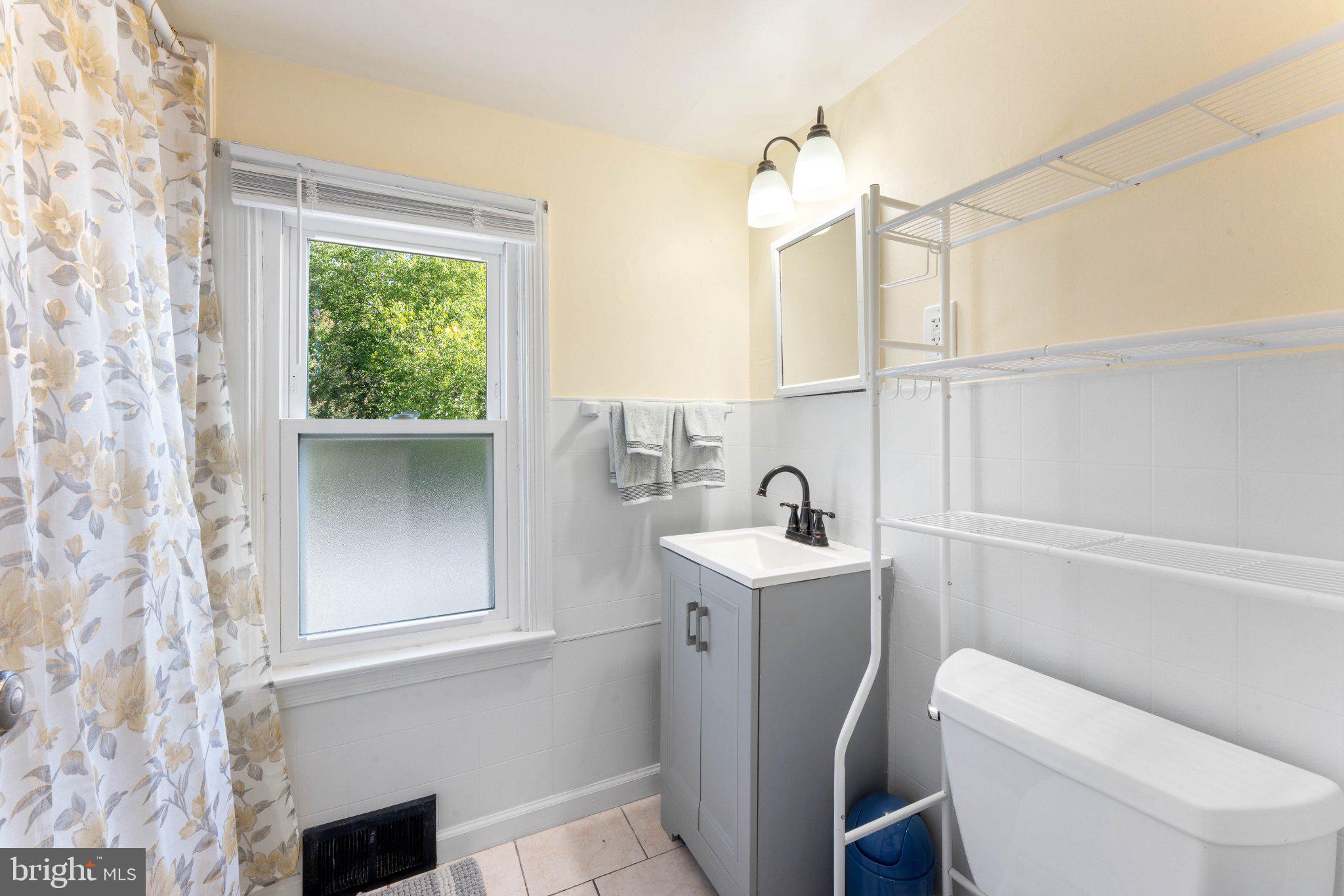329 Ashland Avenue Secane, PA 19018 - Photo 29 of 33 a bathroom with a toilet sink and mirror