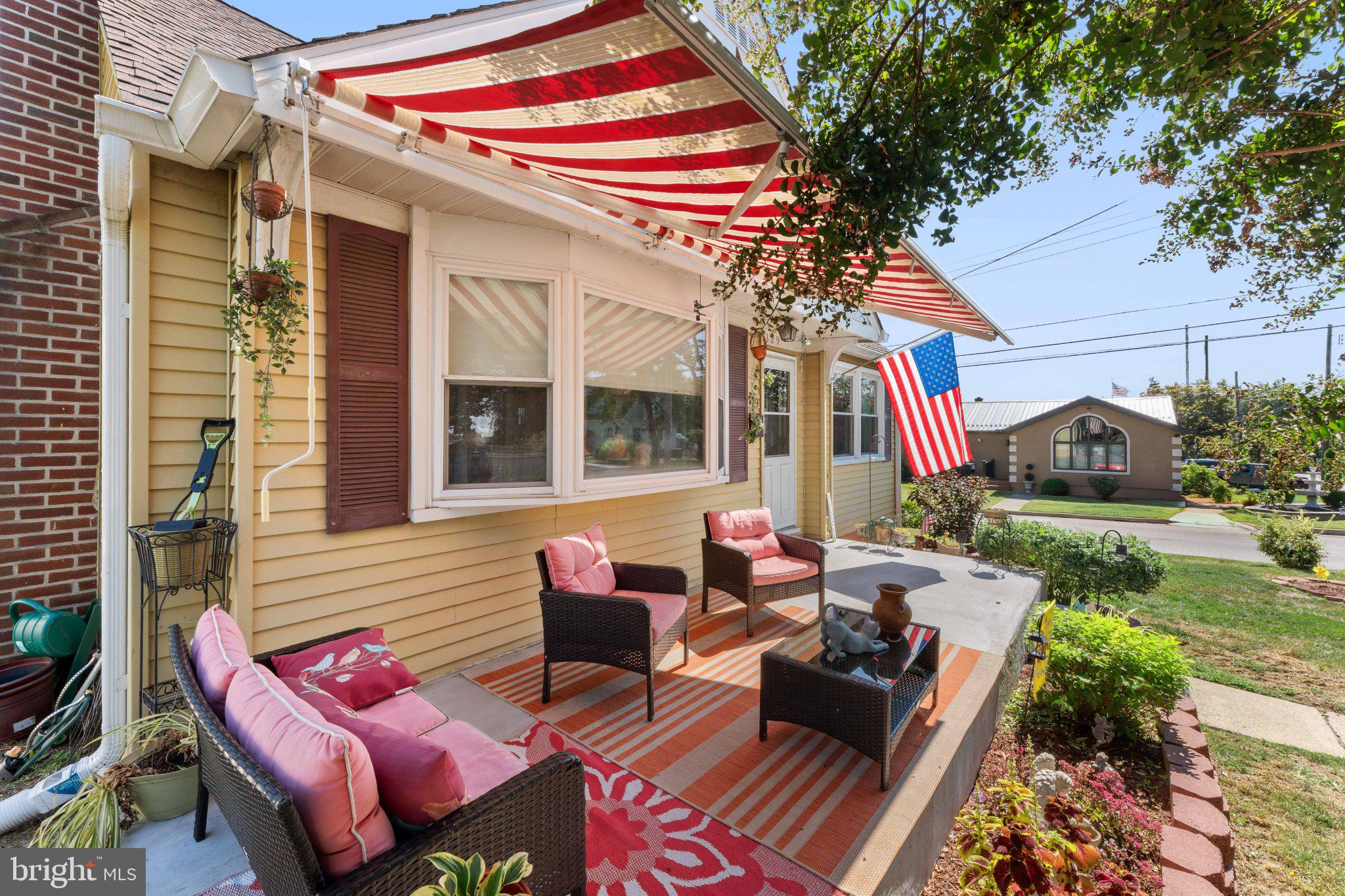 329 Ashland Avenue Secane, PA 19018 - Photo 4 of 33 a view of a patio with couches and chairs under an umbrella