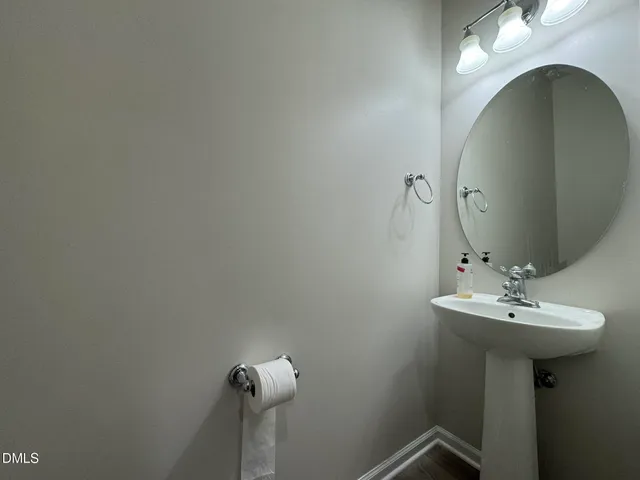 a bathroom with a sink and mirror