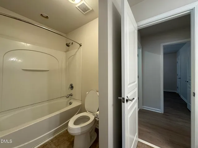 a bathroom with a granite countertop toilet a sink and a shower