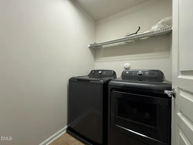a view of storage and utility room with washer and dryer