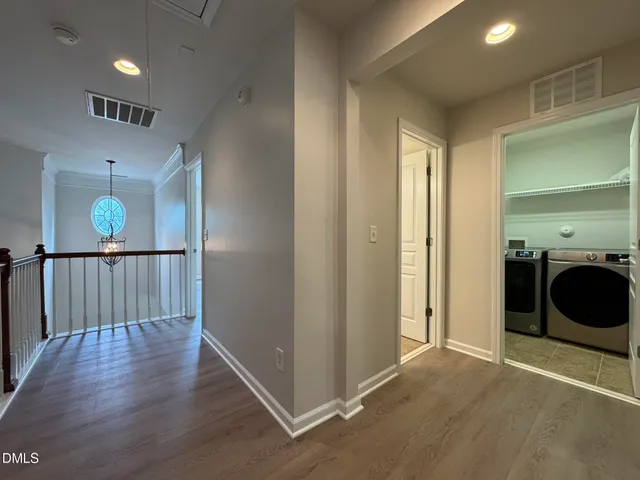 a view of a hallway with washer and dryer