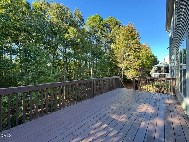 a view of balcony with wooden floor and outdoor seating