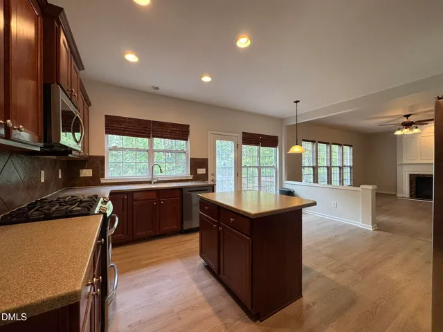 a kitchen with granite countertop a stove and a sink
