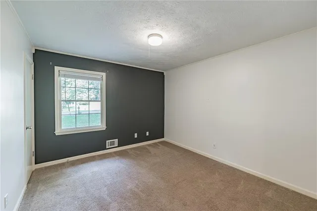 a bathroom with a granite countertop sink a toilet and a mirror