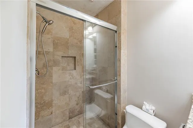 a bathroom with a granite countertop sink and a window