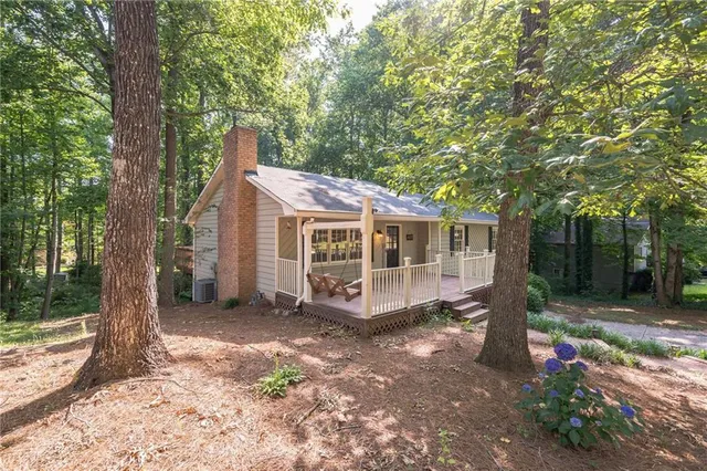 a view of a wooden deck with large trees