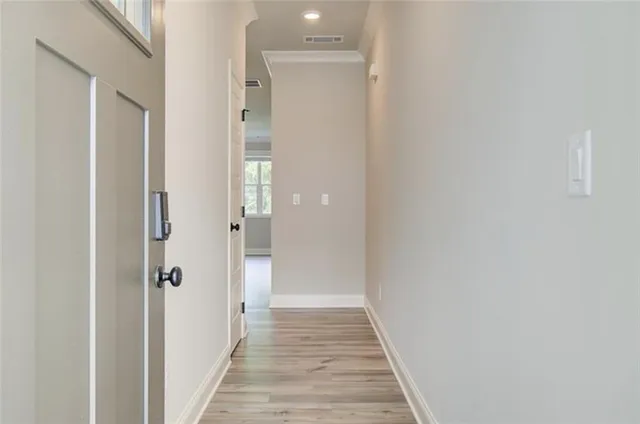 a view of a hallway with wooden floor