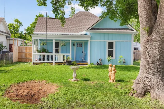 a front view of a house with a yard and porch