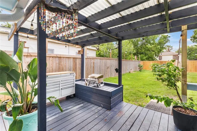 a view of a patio with table and chairs potted plants with wooden floor