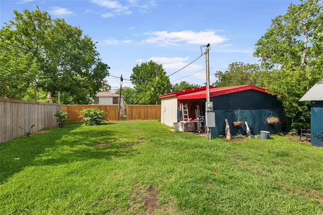 an aerial view of a house with a yard basket ball court and outdoor seating