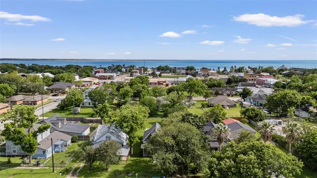 a aerial view of a house with a garden and lake view
