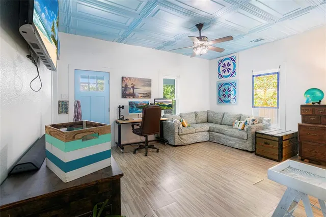 a living room with furniture and wooden floor