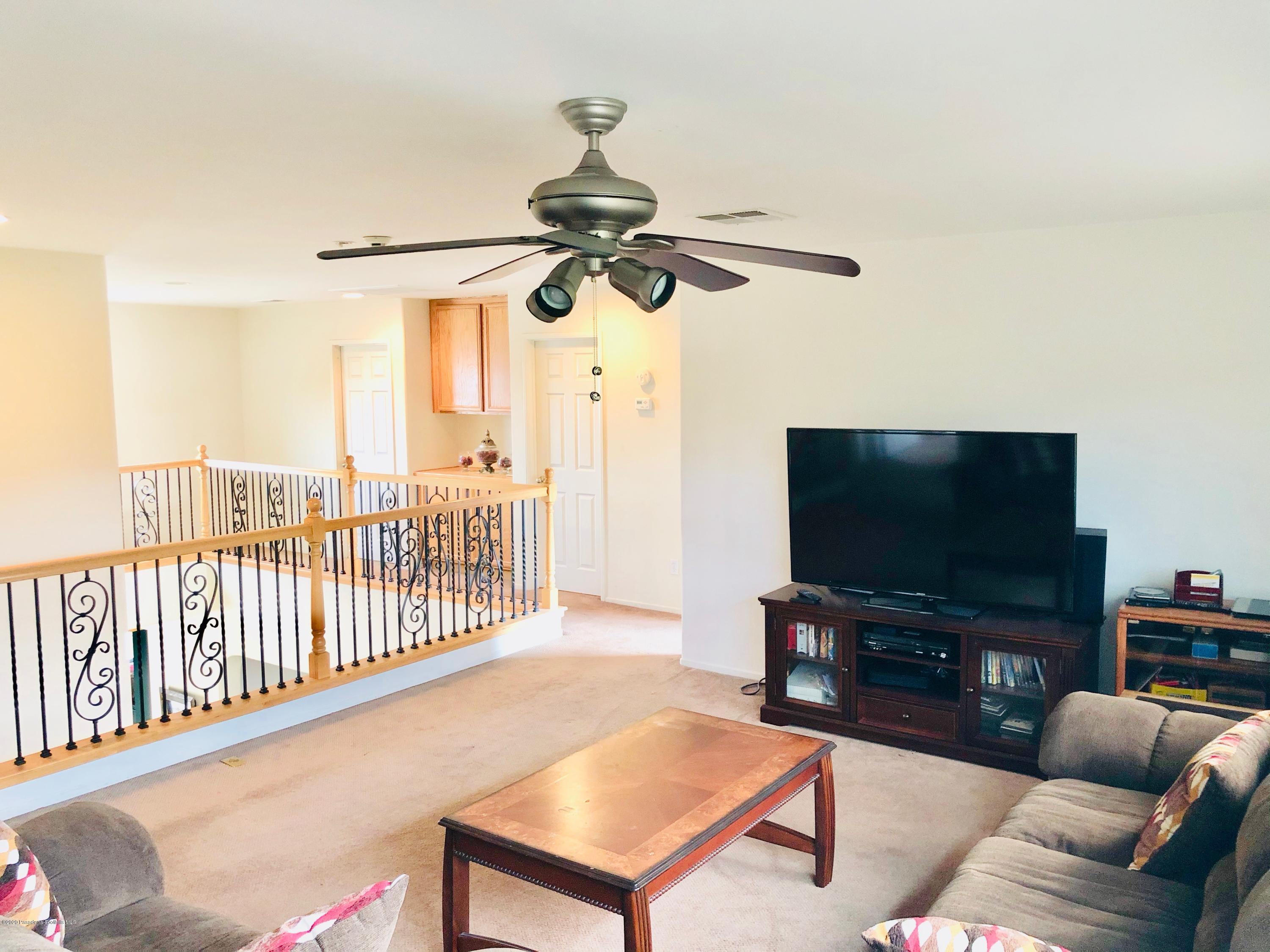 4345 Cloudywing Road Hemet, CA 92545 - Photo 11 of 18 a living room with furniture and a flat screen tv