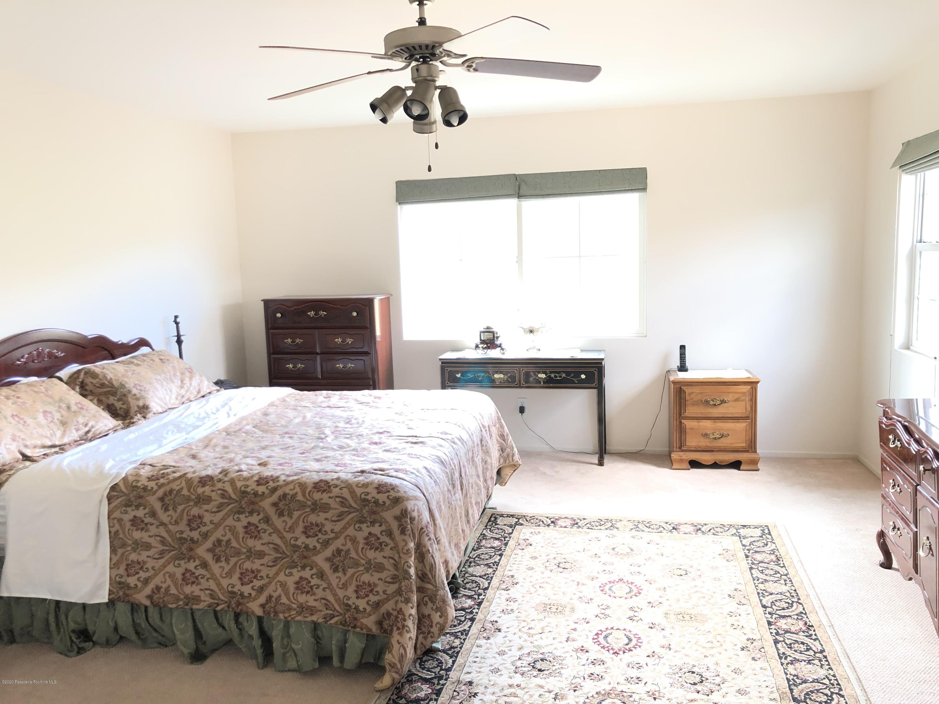 4345 Cloudywing Road Hemet, CA 92545 - Photo 13 of 18 a bedroom with a bed and a chandelier