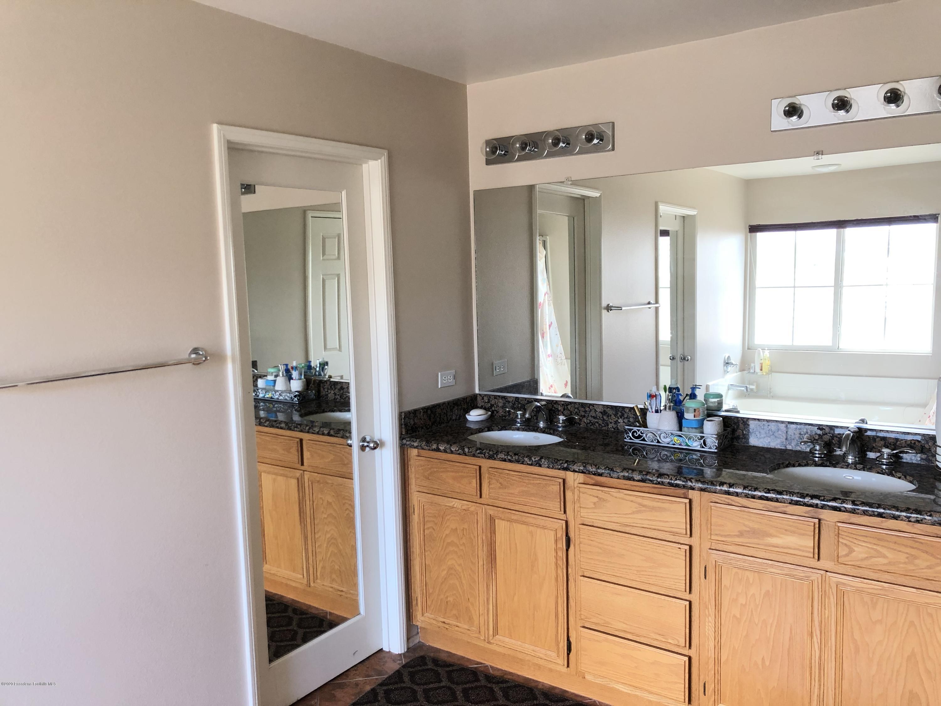 4345 Cloudywing Road Hemet, CA 92545 - Photo 14 of 18 a bathroom with a granite countertop sink and a mirror