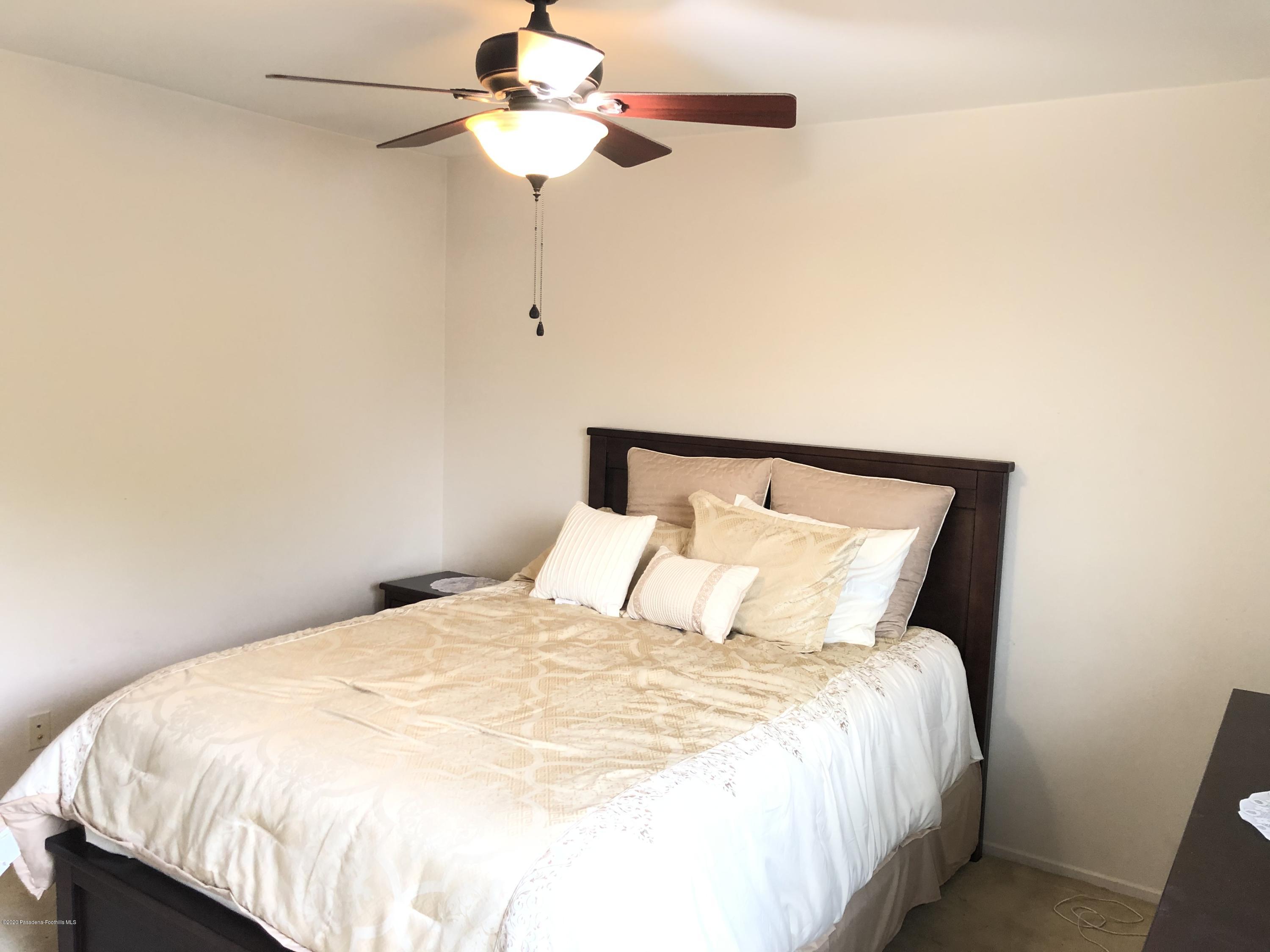 4345 Cloudywing Road Hemet, CA 92545 - Photo 17 of 18 a bedroom with a bed and a ceiling fan