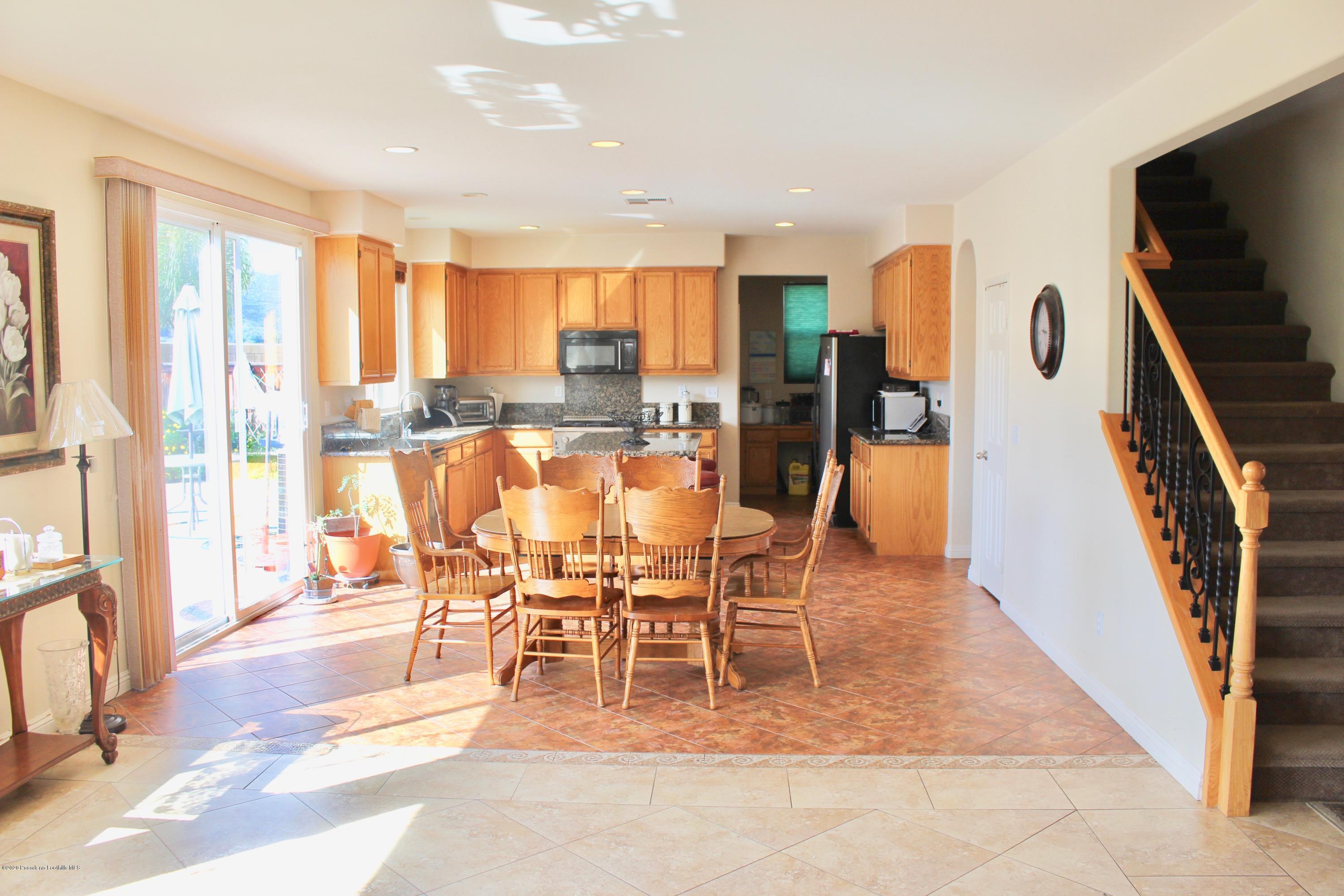 4345 Cloudywing Road Hemet, CA 92545 - Photo 6 of 18 a dining room with furniture water view and a floor to ceiling window