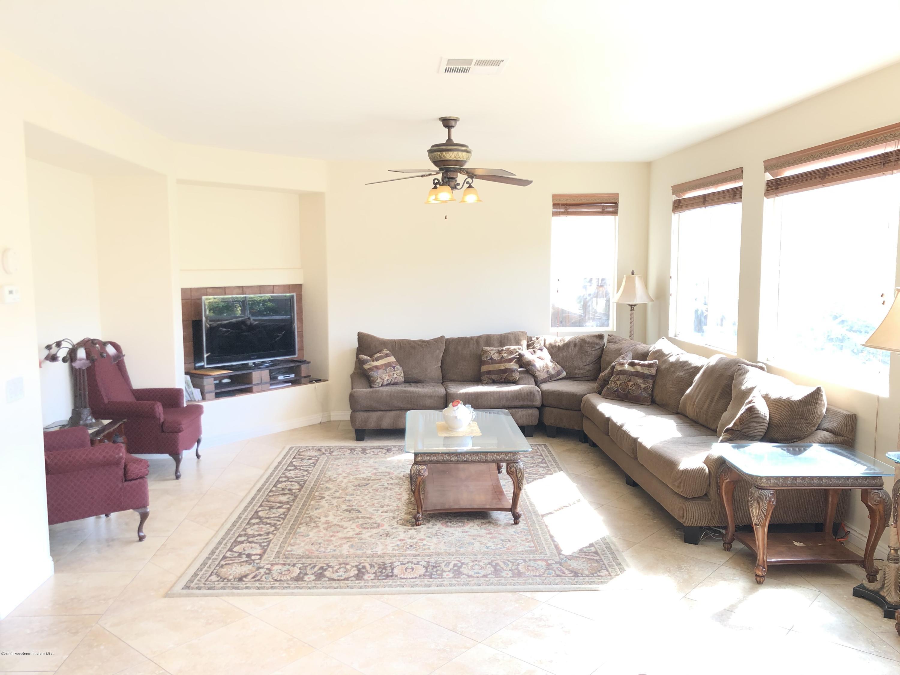 4345 Cloudywing Road Hemet, CA 92545 - Photo 8 of 18 a living room with furniture and a fireplace