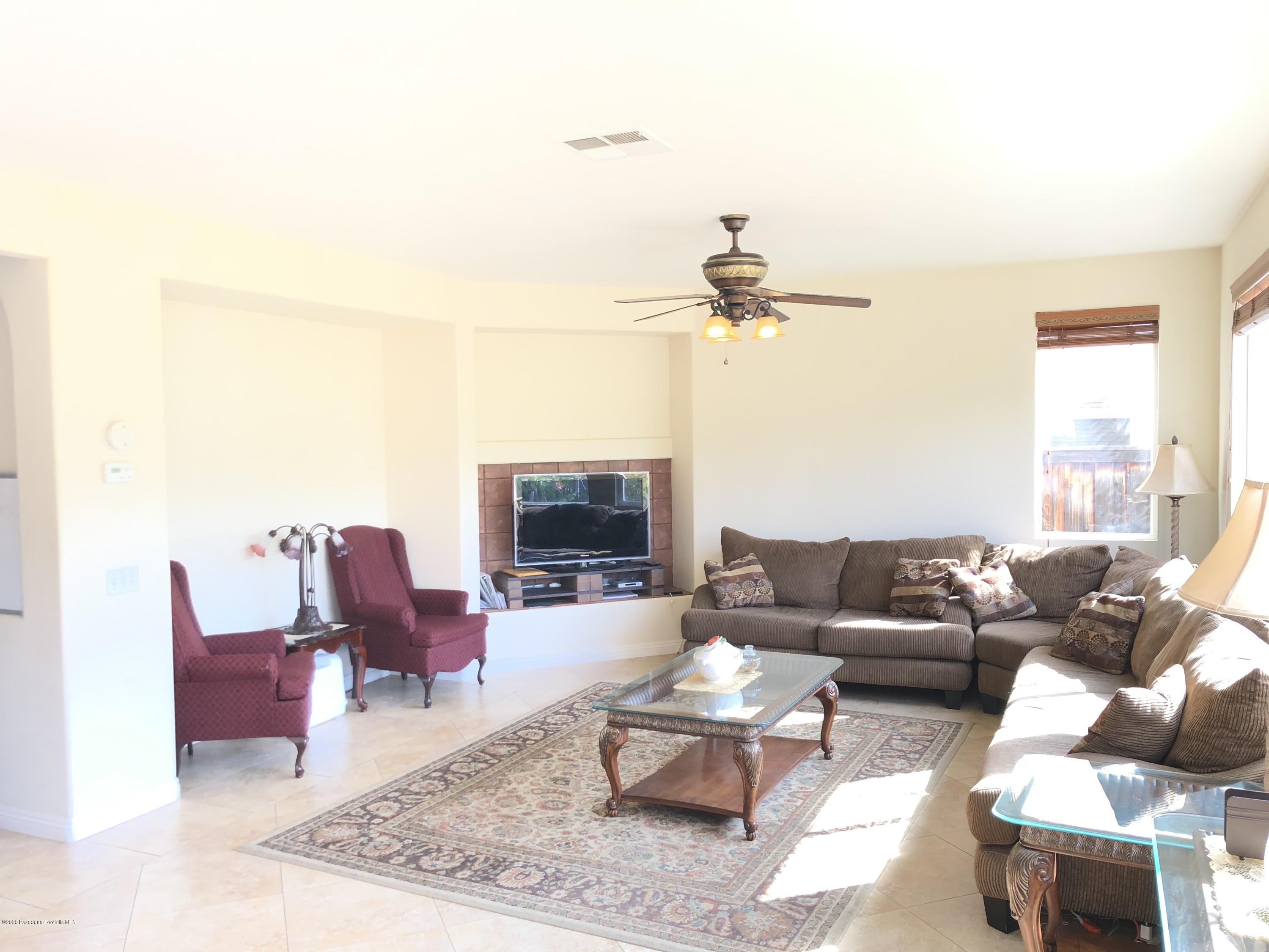 4345 Cloudywing Road Hemet, CA 92545 - Photo 9 of 18 a living room with furniture and a fireplace