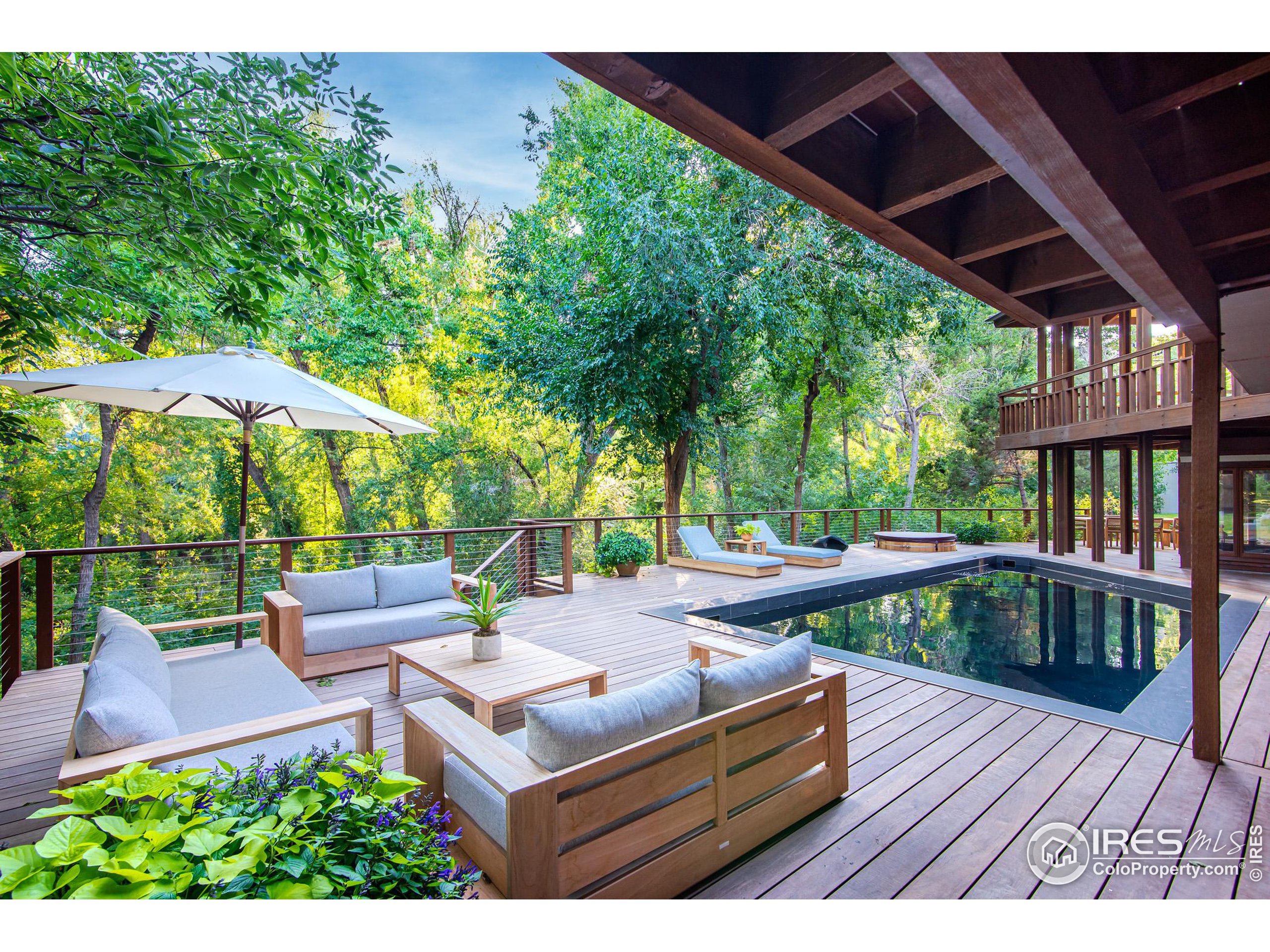 2323 4th Street Boulder, CO 80302 - Photo 33 of 40 a view of backyard with seating space and trees in the background