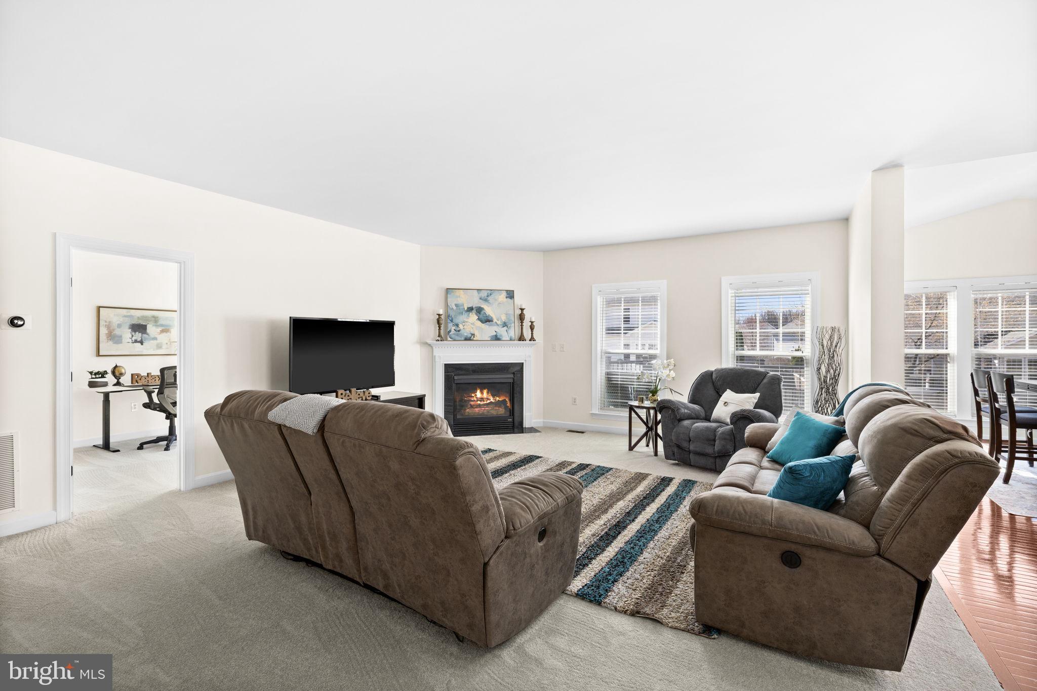 4185 Agency Loop Triangle, VA 22172 - Photo 18 of 46 a living room with furniture a large window and a fireplace