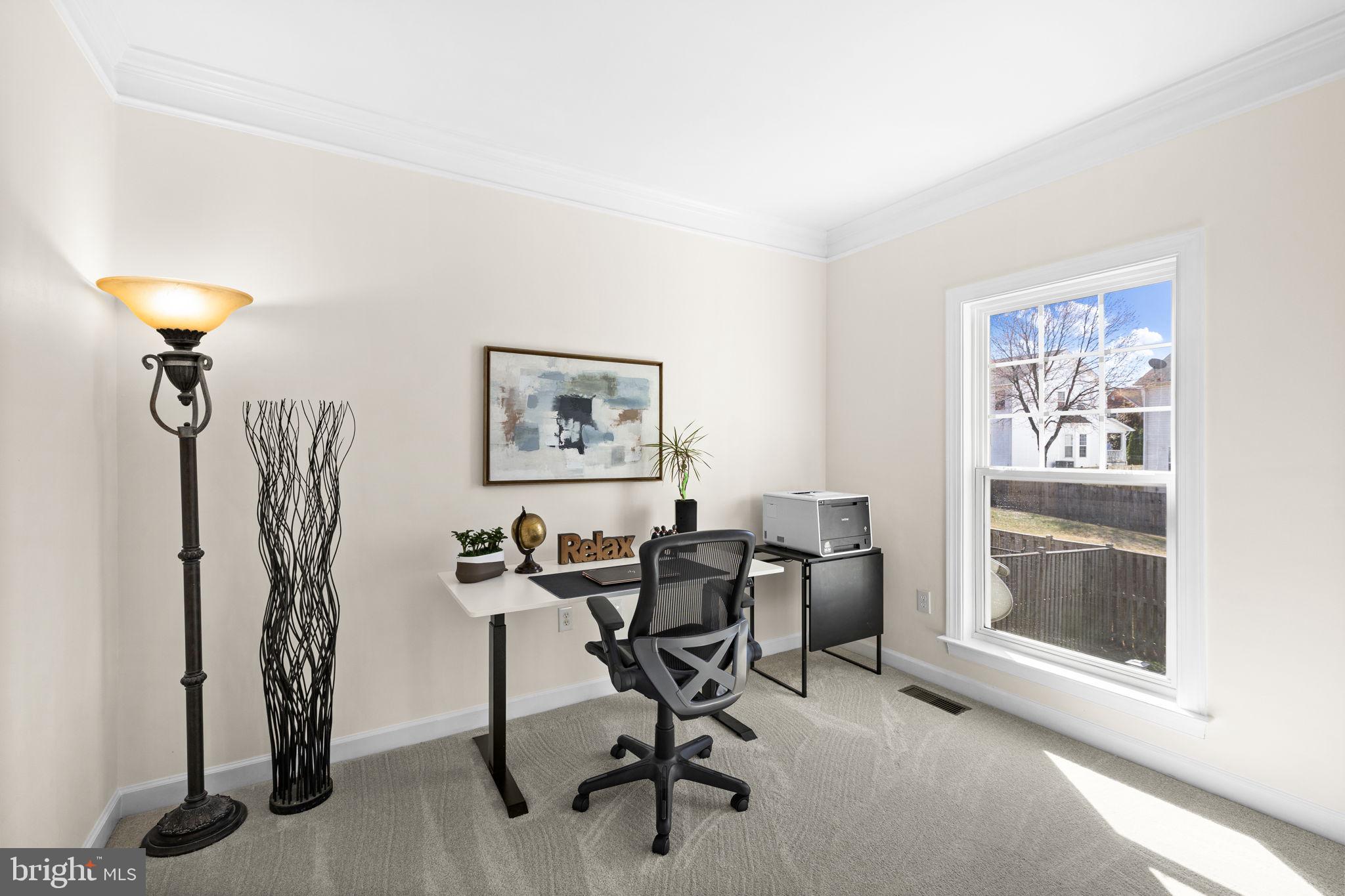 4185 Agency Loop Triangle, VA 22172 - Photo 23 of 46 a view of a workspace with furniture and a window