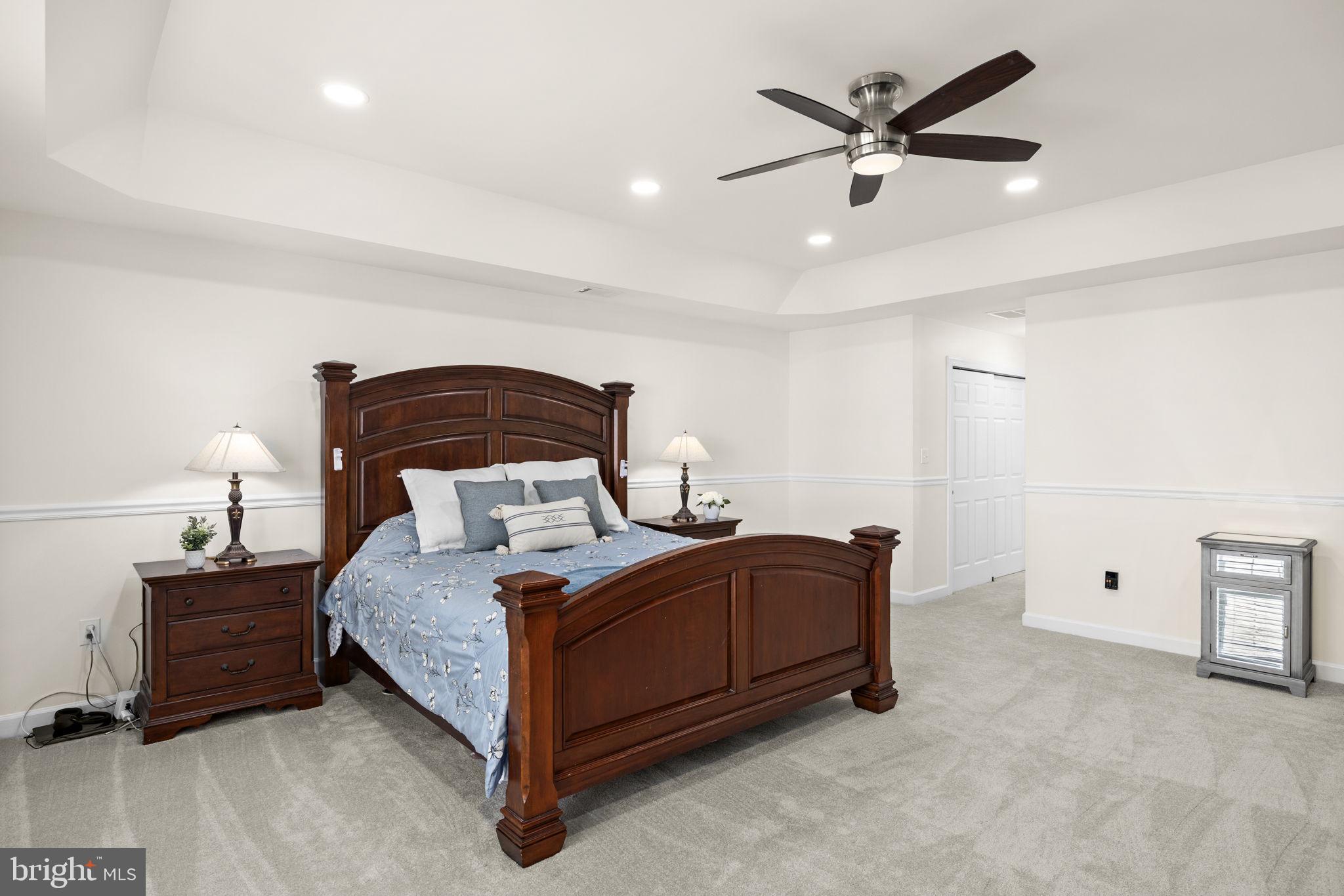 4185 Agency Loop Triangle, VA 22172 - Photo 27 of 46 a bedroom with a bed and a ceiling fan