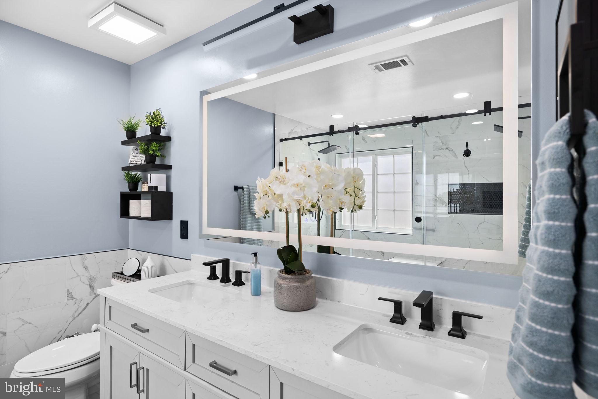 4185 Agency Loop Triangle, VA 22172 - Photo 30 of 46 a bathroom with a double vanity sink and a bathtub