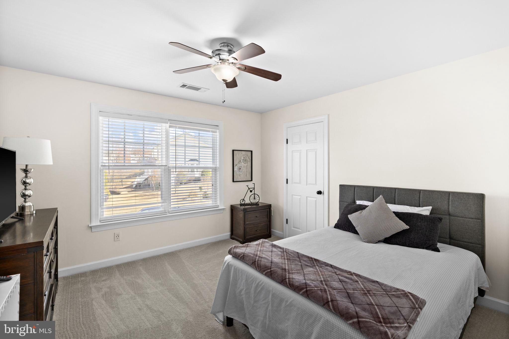 4185 Agency Loop Triangle, VA 22172 - Photo 32 of 46 a bedroom with a bed and wooden floor