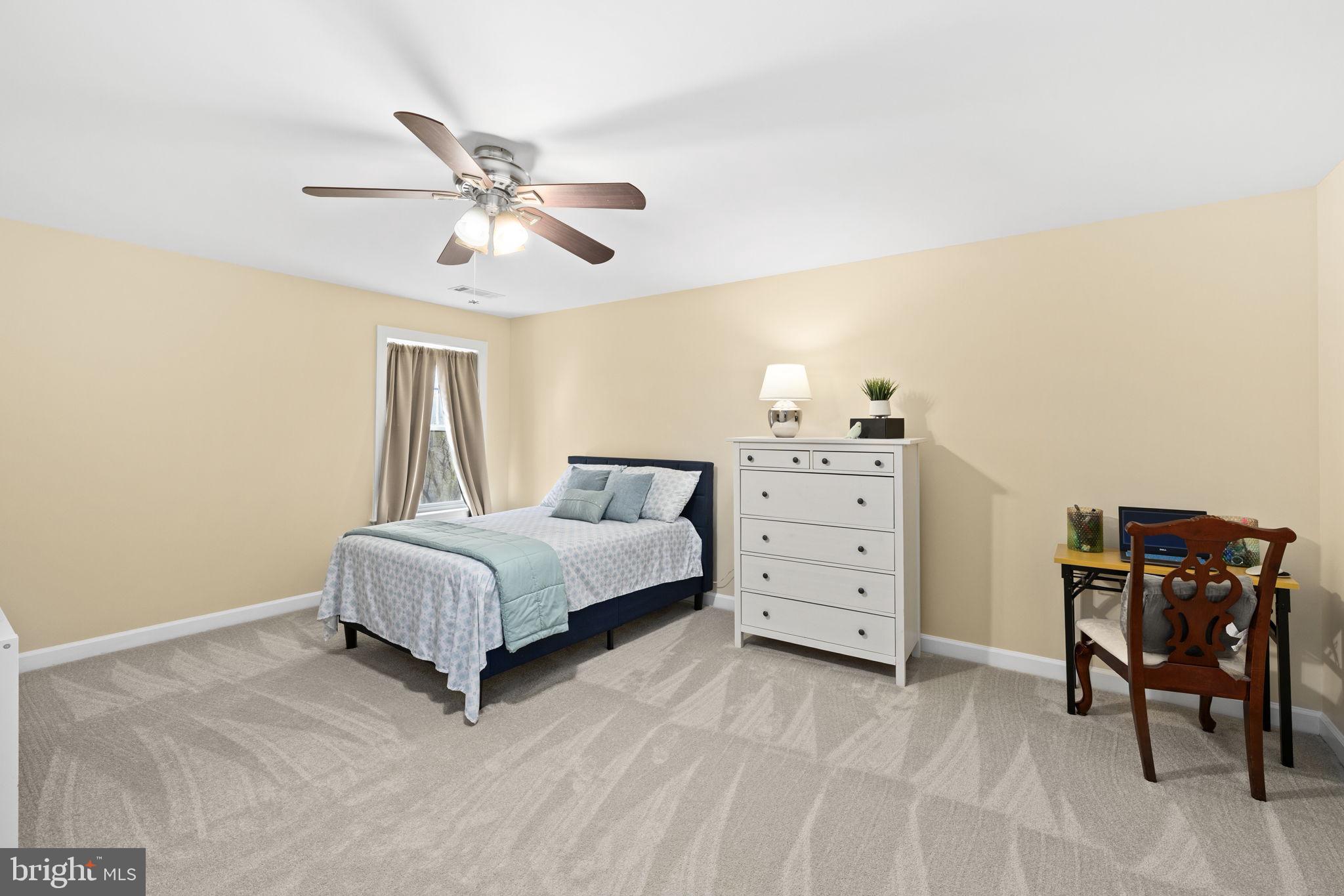 4185 Agency Loop Triangle, VA 22172 - Photo 33 of 46 a spacious bedroom with a bed and a cabinets