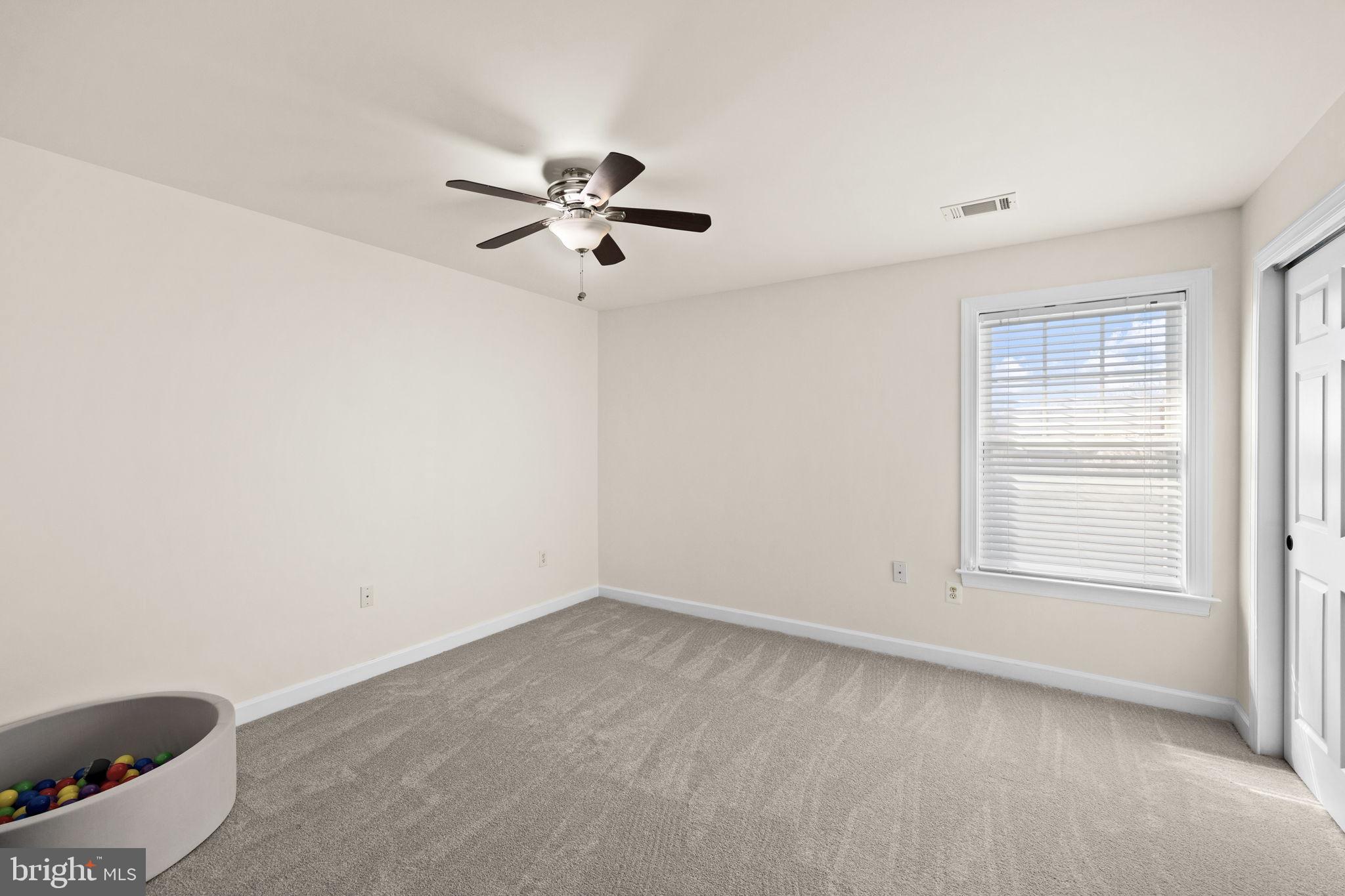 4185 Agency Loop Triangle, VA 22172 - Photo 34 of 46 an empty room with a window and a fan