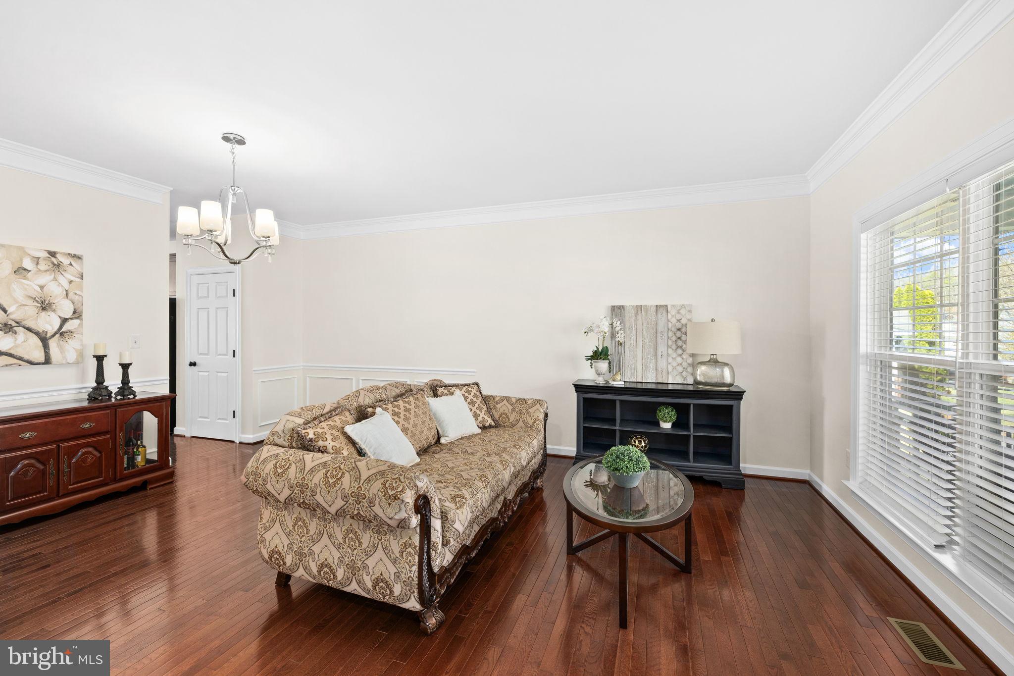 4185 Agency Loop Triangle, VA 22172 - Photo 9 of 46 a living room with furniture and wooden floor