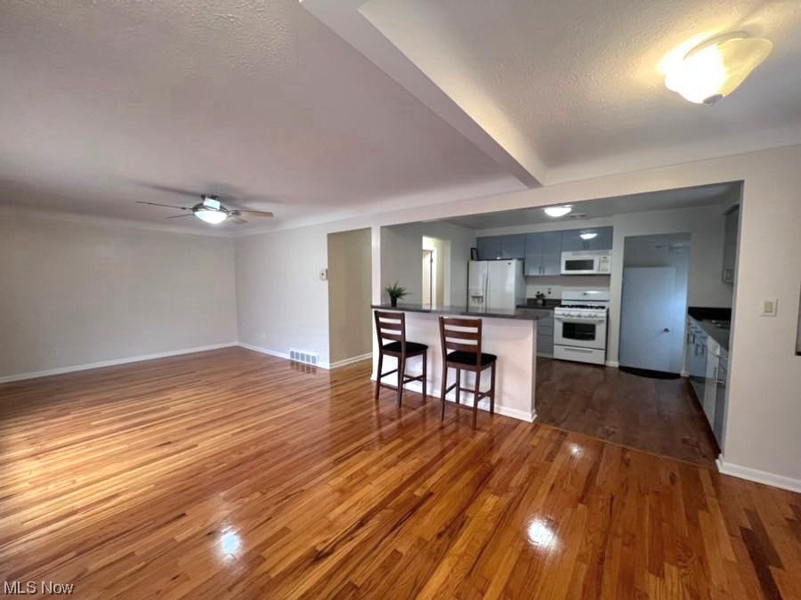 11701 Fordham Road Garfield Heights, OH 44125 - Photo 19 of 19 living room/ dining room area featuring open floor plan with natural hardwood flooring and freshly repainted.