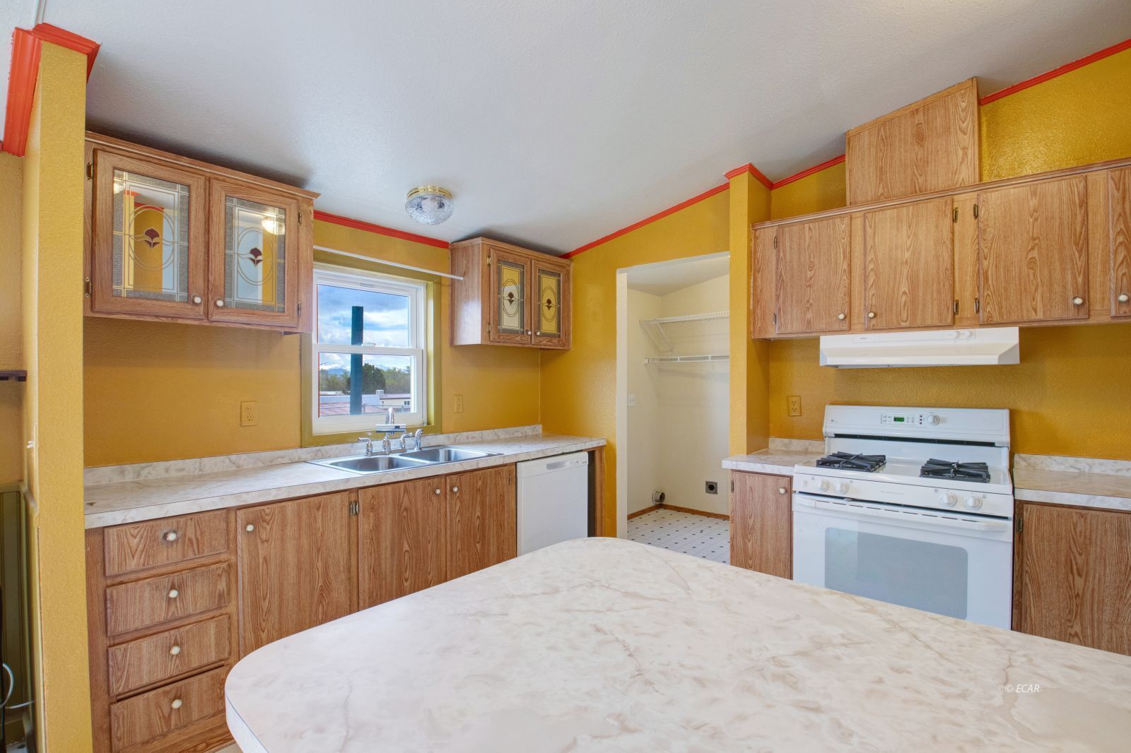 378 Spring Valley Parkway Spring Creek, NV 89815 - Photo 8 of 32 a kitchen with a stove a sink and a refrigerator