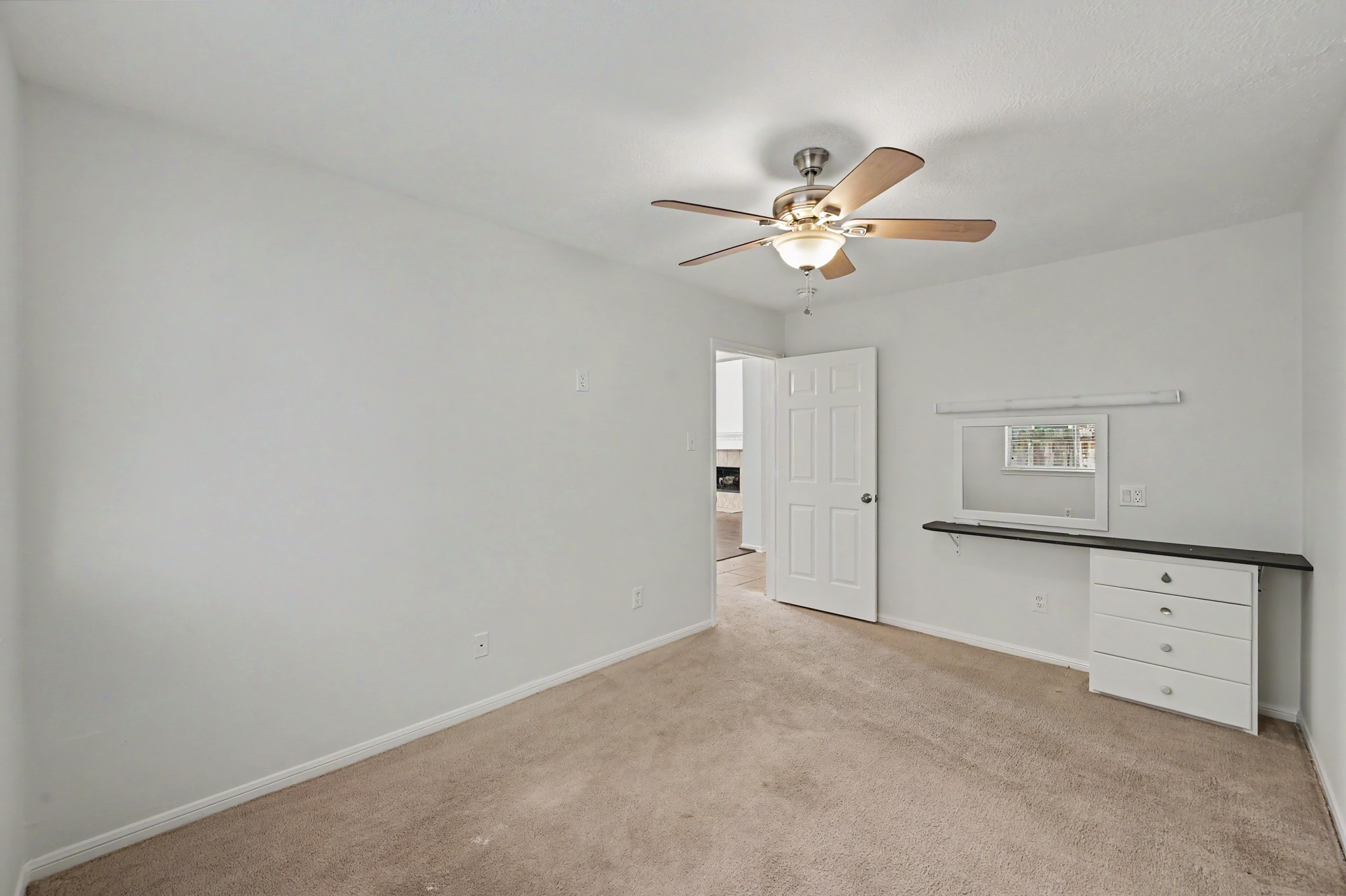 14 South Rambling Ridge Place The Woodlands, TX 77385 - Photo 24 of 42 Secondary bedroom featuring a built-in desk and drawers.