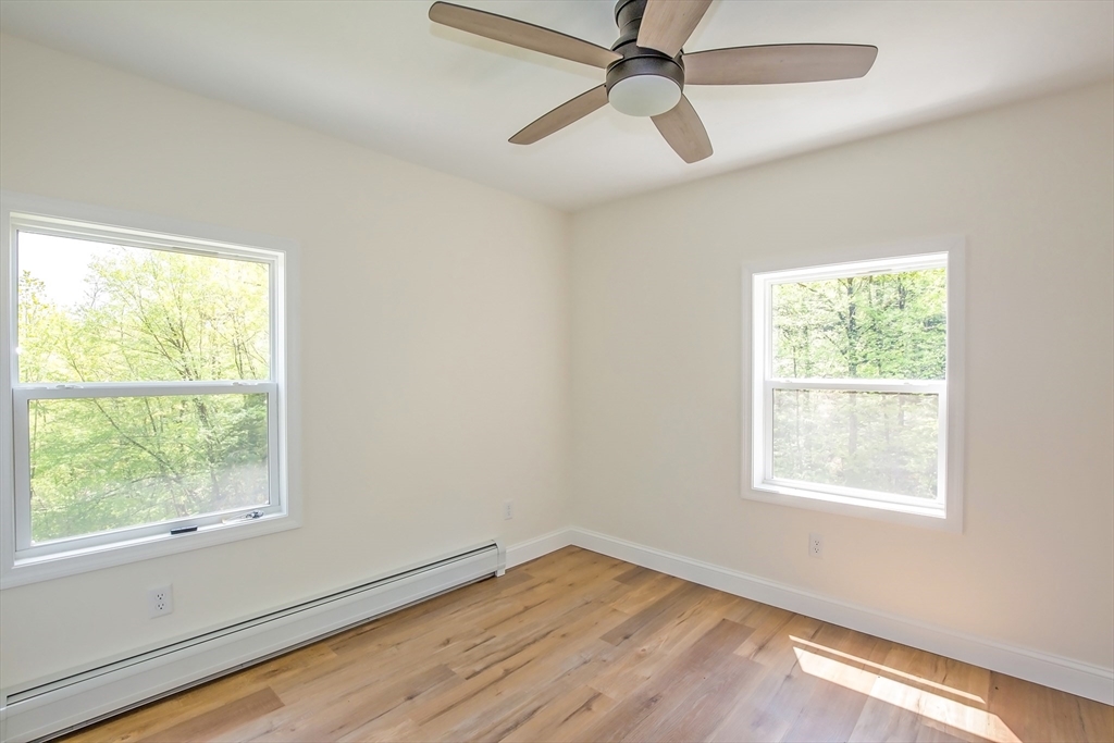 165 Sandisfield Road Sandisfield, MA 01255 - Photo 31 of 37 a view of empty room with wooden floor and fan