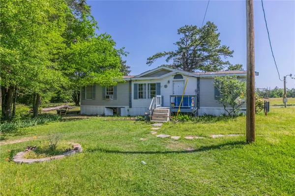 a swimming pool with lots of green space
