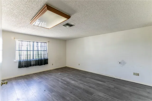 a bathroom with a granite countertop sink and a bathtub