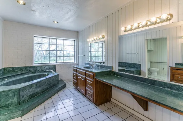 a large kitchen with kitchen island a sink and a stove