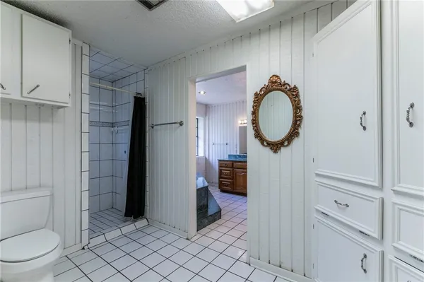a bathroom with a toilet and a shower