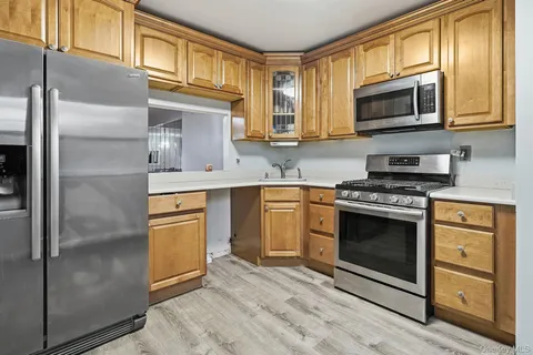 a kitchen with stainless steel appliances granite countertop a stove microwave and refrigerator