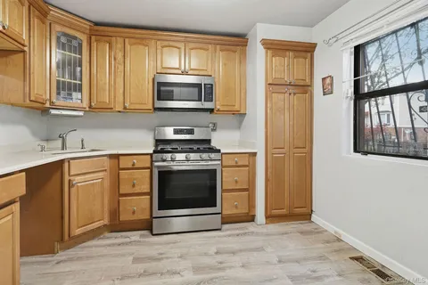 a kitchen with stainless steel appliances granite countertop a stove a sink and a microwave