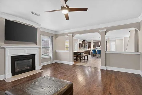 a living room with furniture a fireplace and a flat screen tv