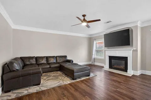 a living room with furniture a flat screen tv and a fireplace