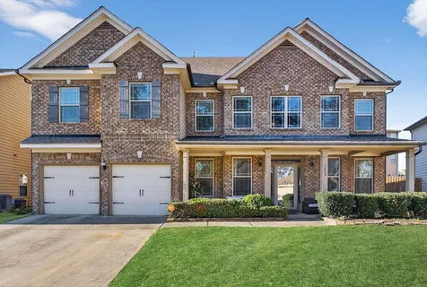 front view of brick house with a yard