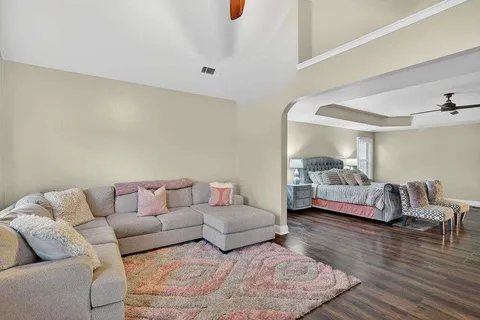 a living room with furniture and a wooden floor